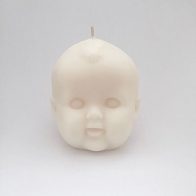 Candle shaped as baby head